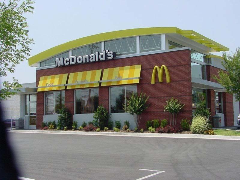 A McDonald 's restaurant with a yellow awning