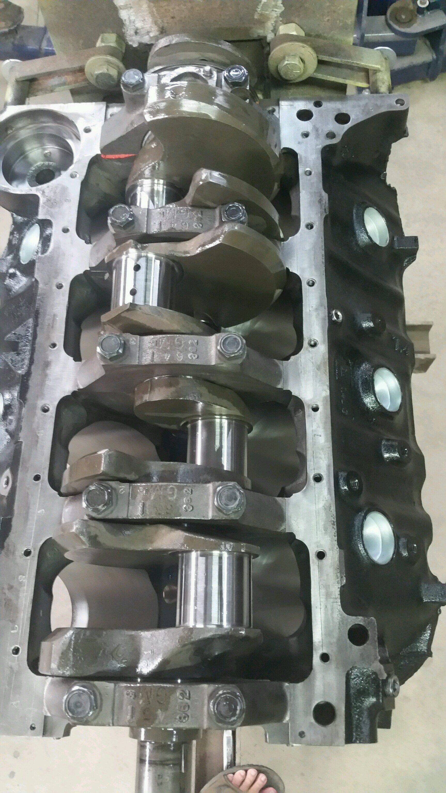 A close up of a crankshaft on a table.