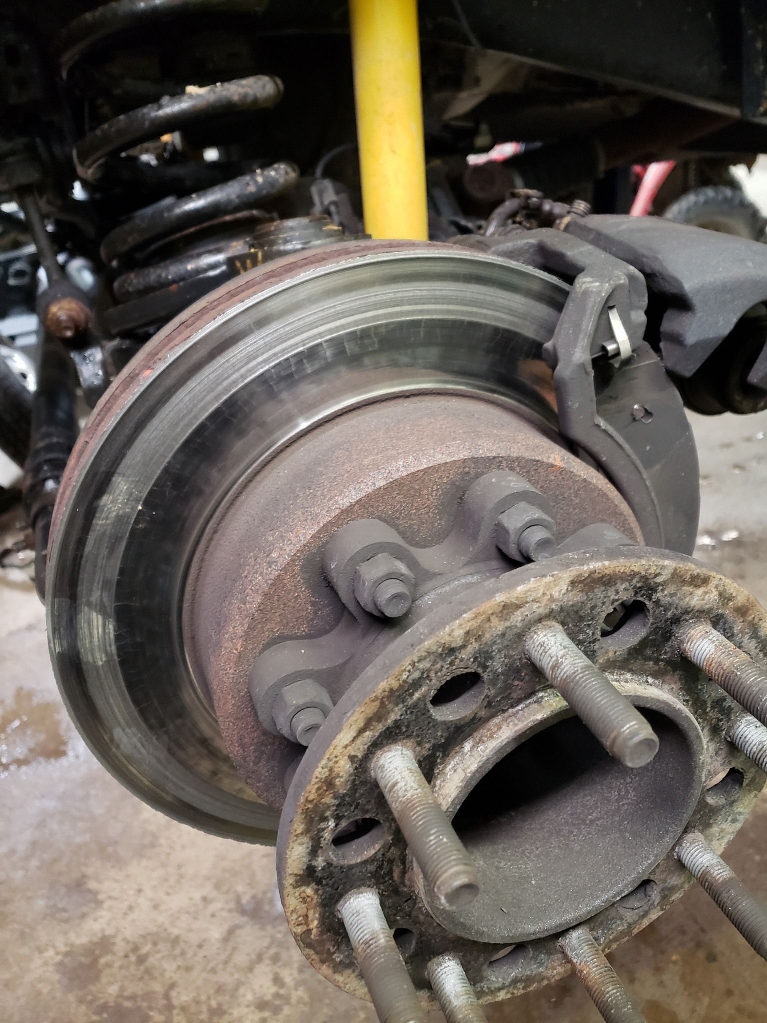 A close up of a brake disc on a car.
