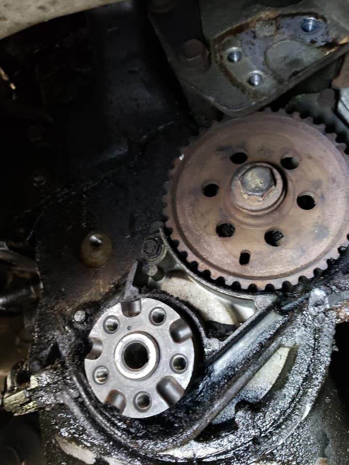 A close up of a gear on a car engine.