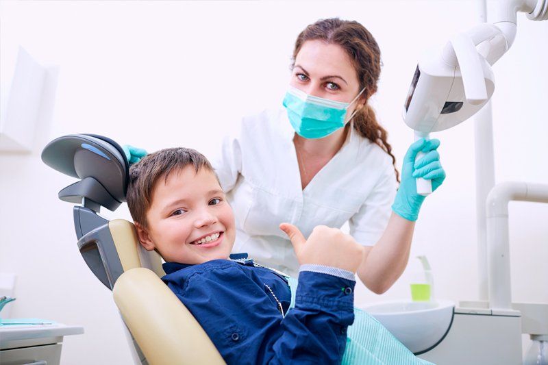 Happy Young Boy with a Dentist — Lodi, CA — Kevin L. Fleming DDS