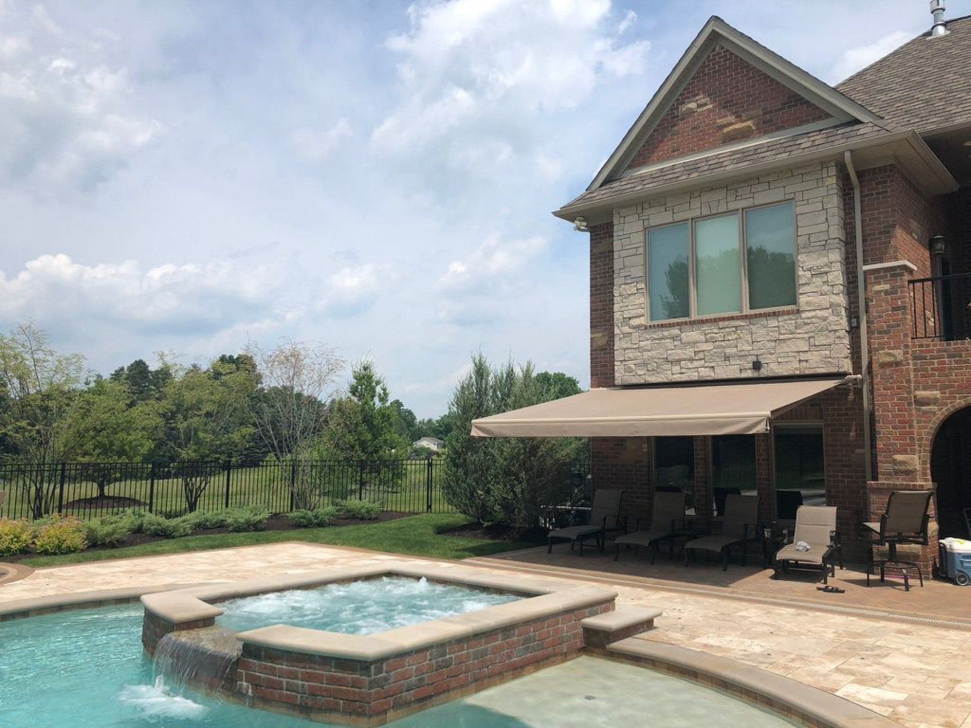 A large house with a swimming pool and patio area