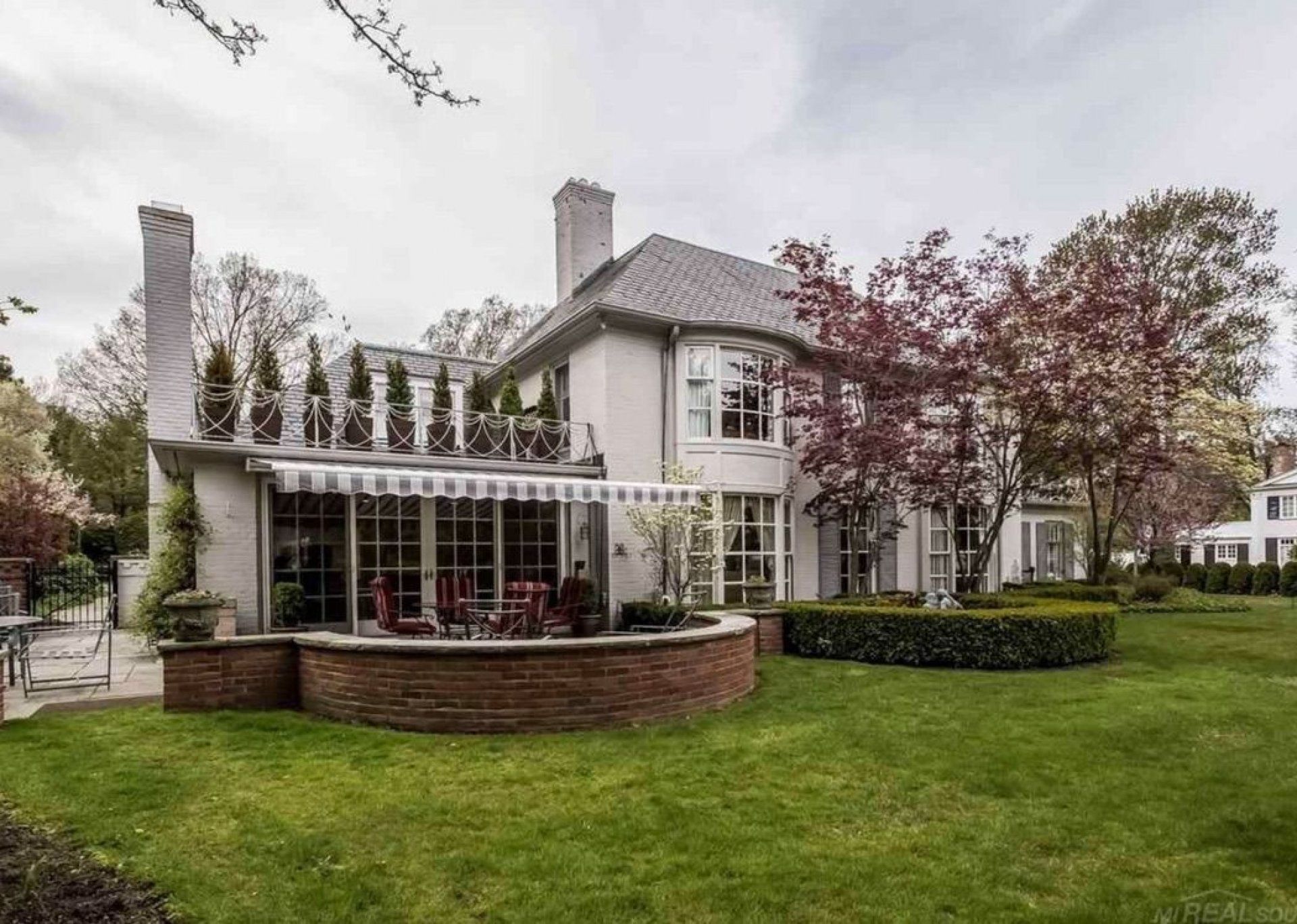 A large white house with a large lawn in front of it