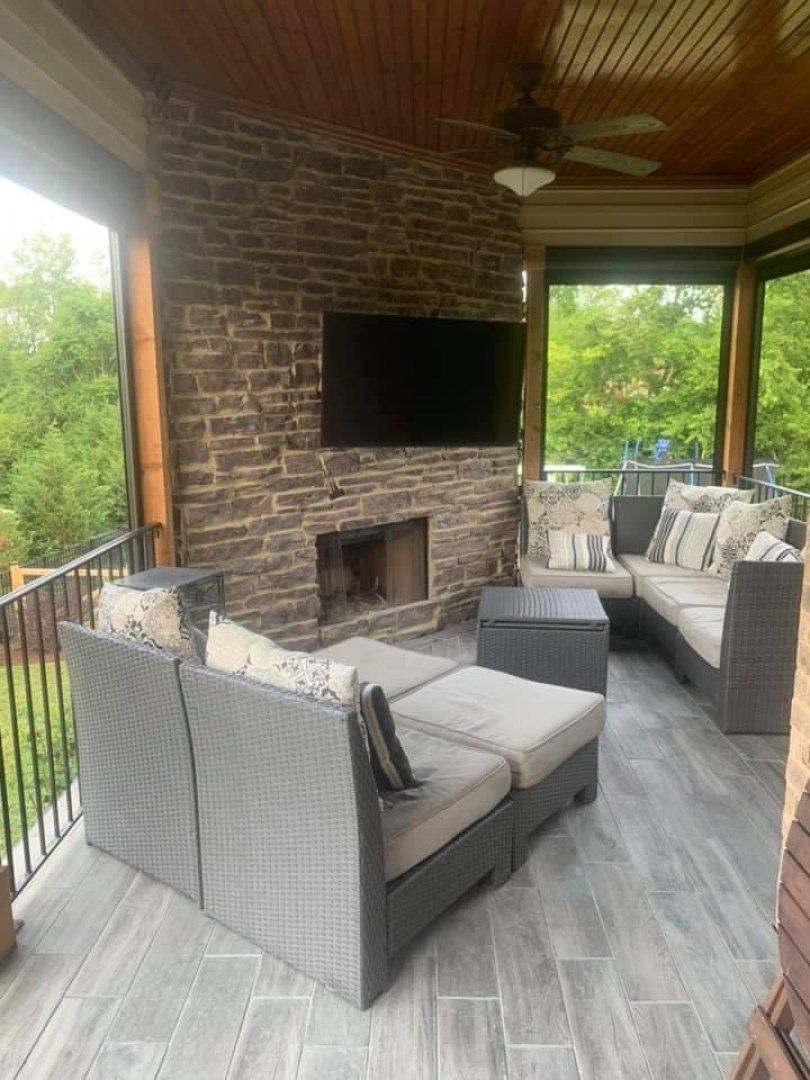 A living room with a fireplace and a flat screen tv.