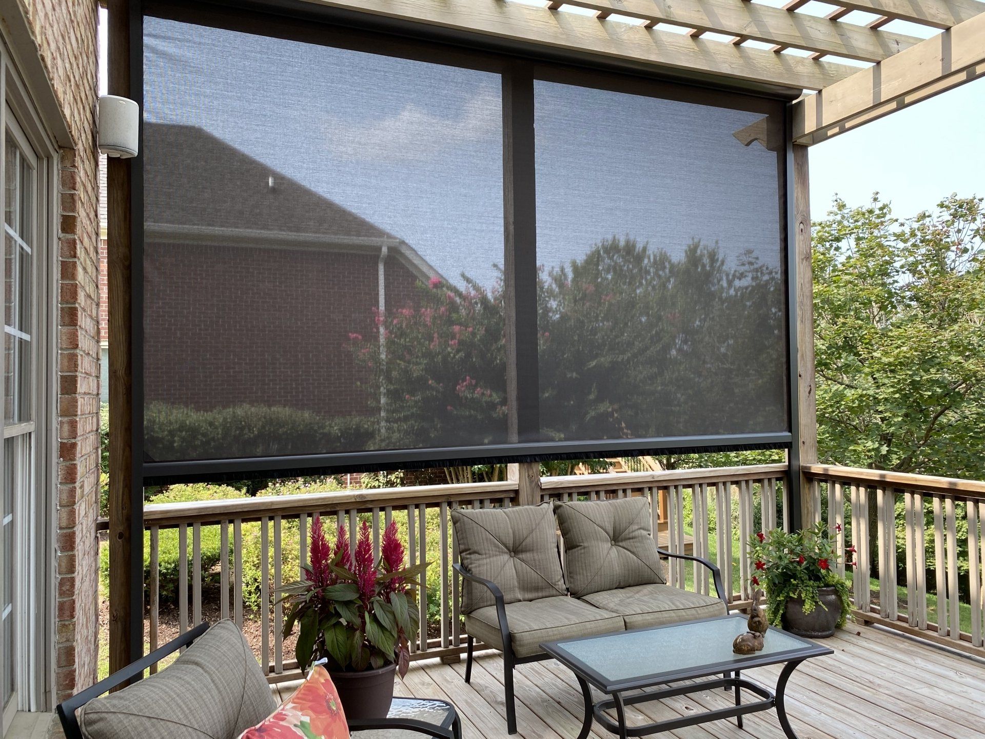 A screened in porch with a couch and a table