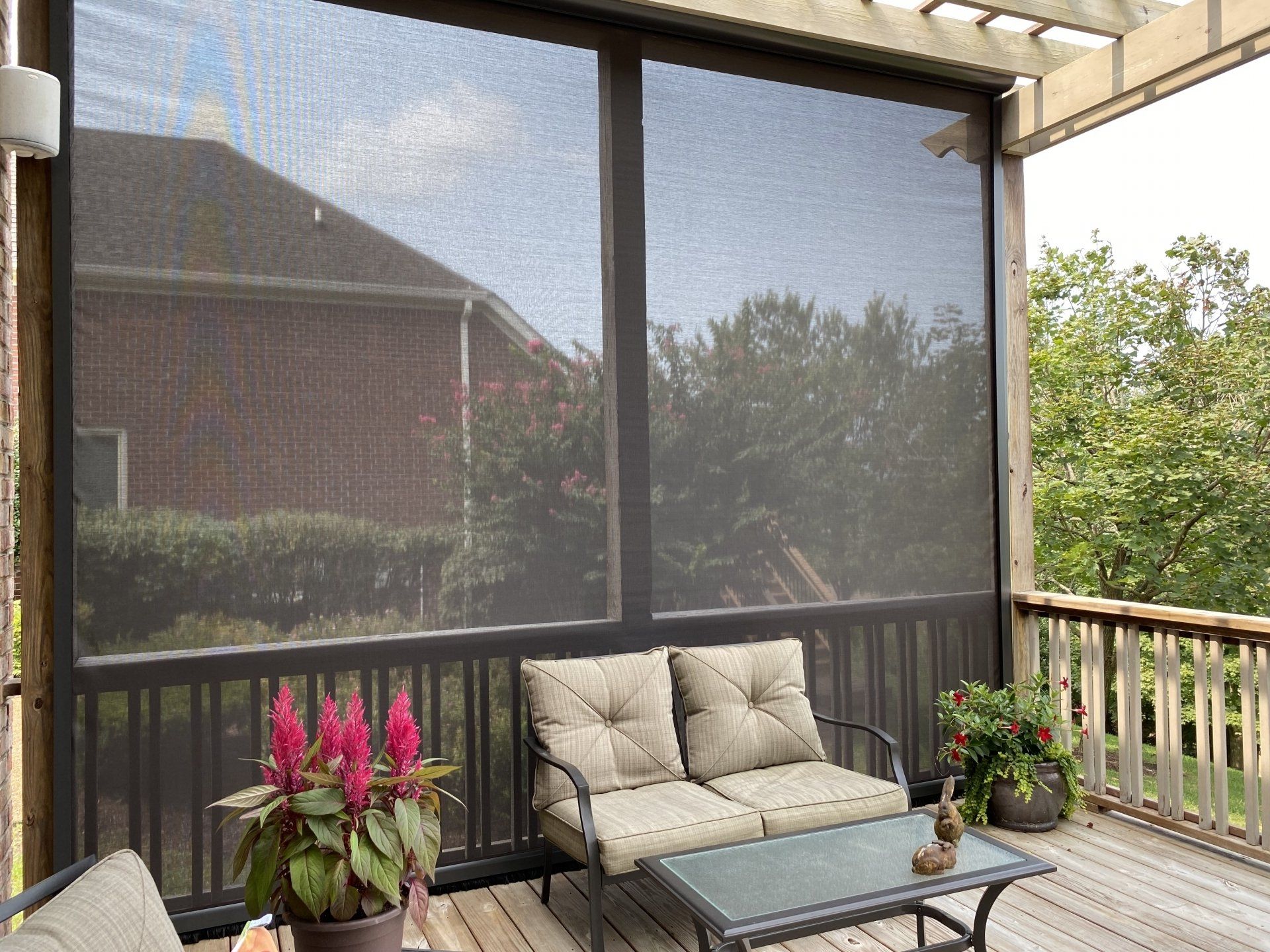 A screened in porch with a couch and a table