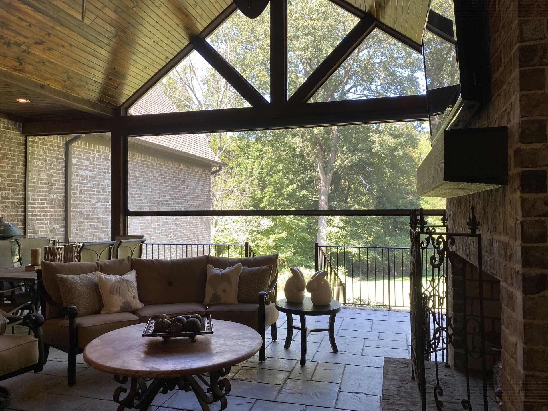 A living room with a couch , table , chairs and a fireplace.