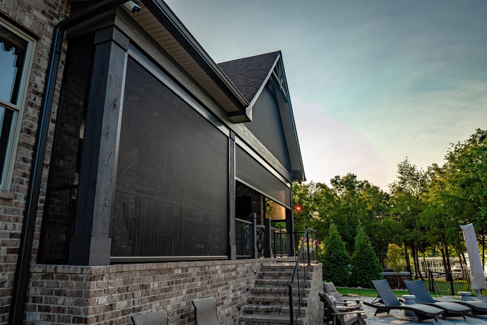 A house with a screened in porch and stairs leading up to it