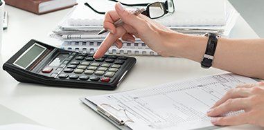 Woman Making Calculations - Attorneys in McMinnville, OR