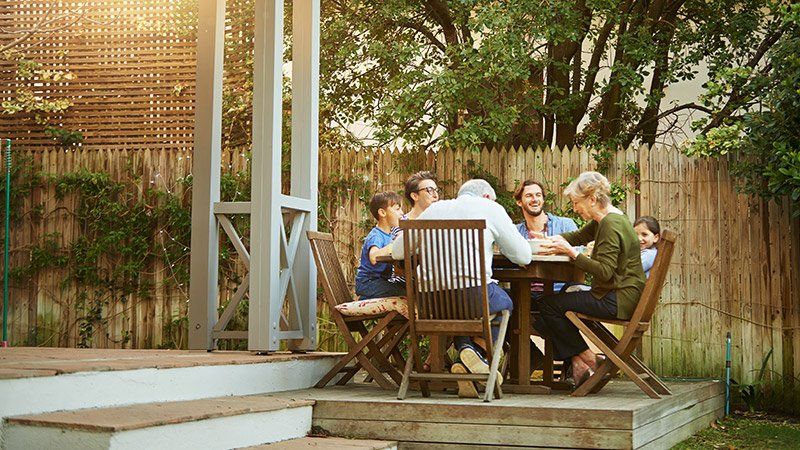 family sits around table outdoors