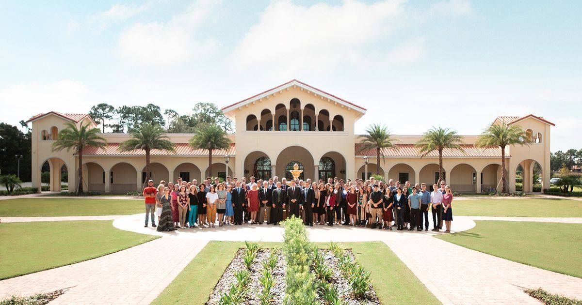 A large group of people standing in front of a large building