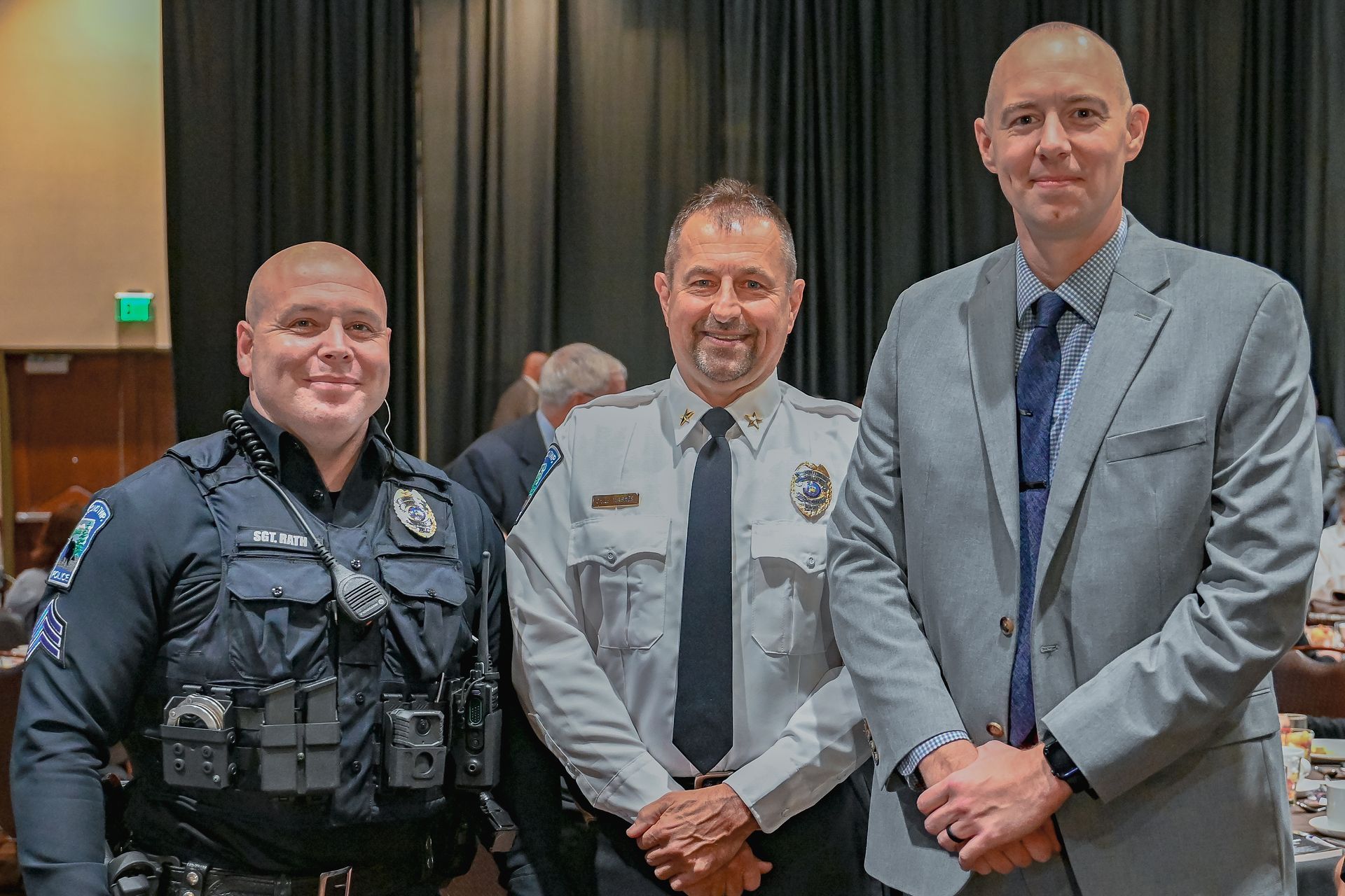 Three men in suits and ties are posing for a picture.