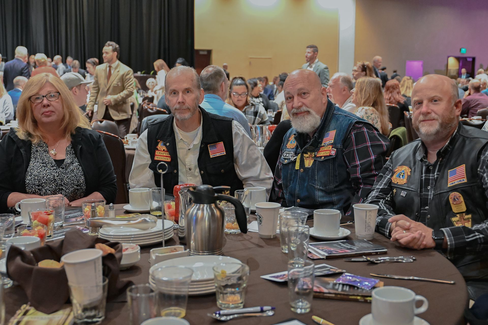 A group of people are sitting at a table in a room.