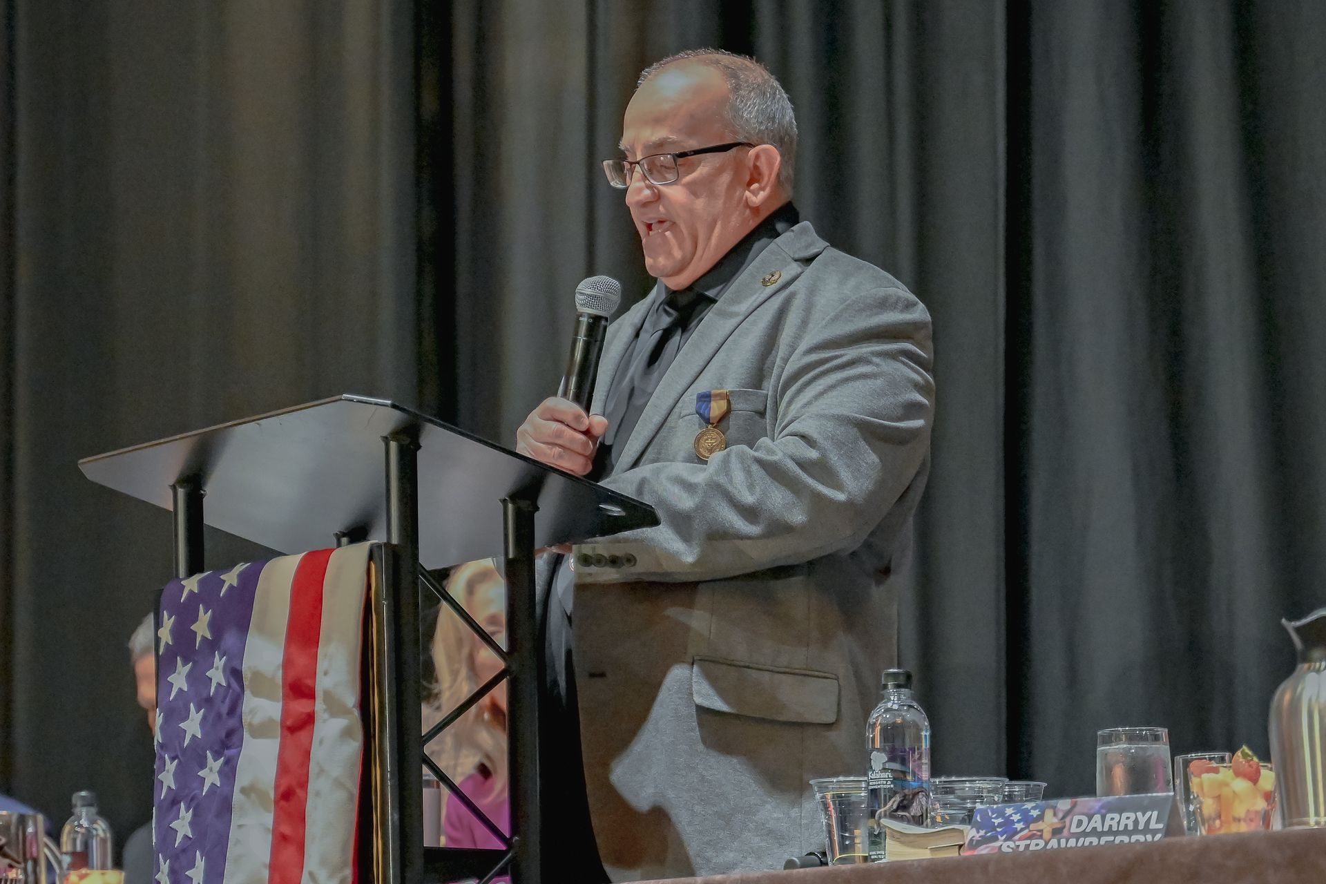 A man is standing at a podium giving a speech.