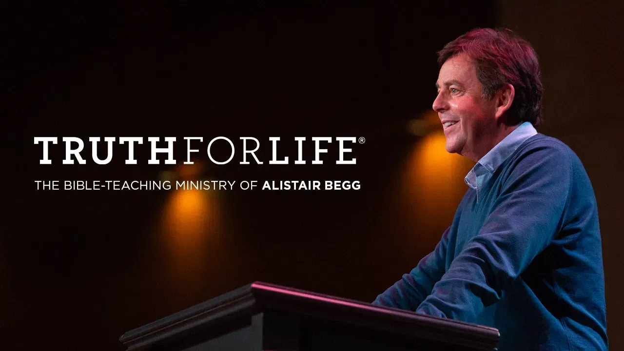 A man is standing at a podium giving a speech titled truth for life