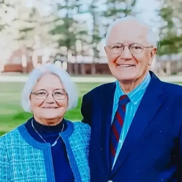 A man and a woman are posing for a picture together