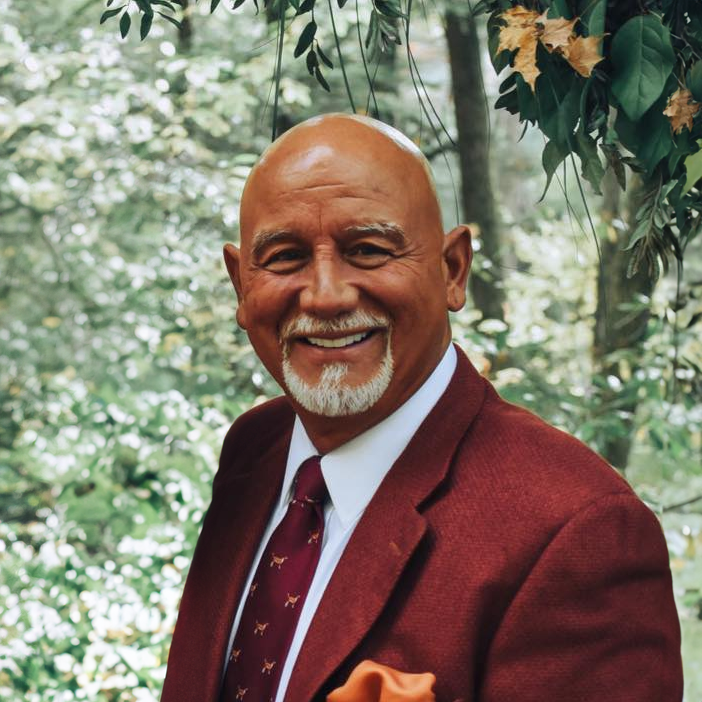 Vincent Trapasso wearing a red suit and tie