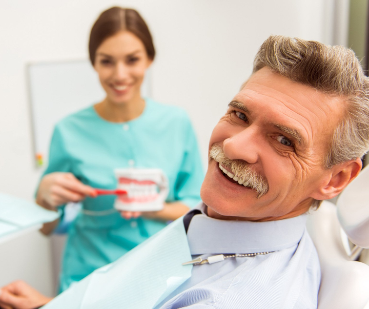 Male Senior Sitting on the Dentist Chair — Louisville, OH — Louisville Dental Clinic