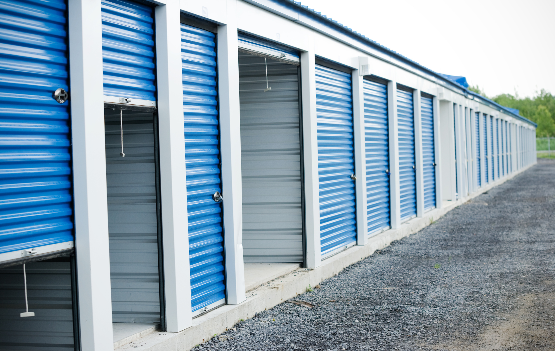 A row of blue and white storage units with their doors open.