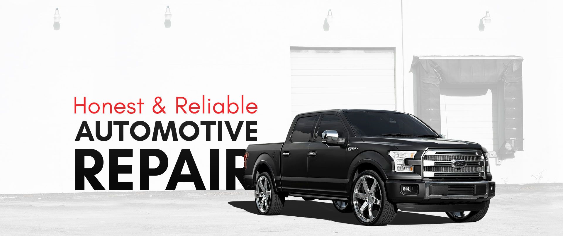 Black pickup truck near white wall with