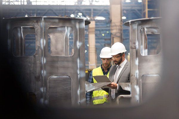 two workers reviewing paper