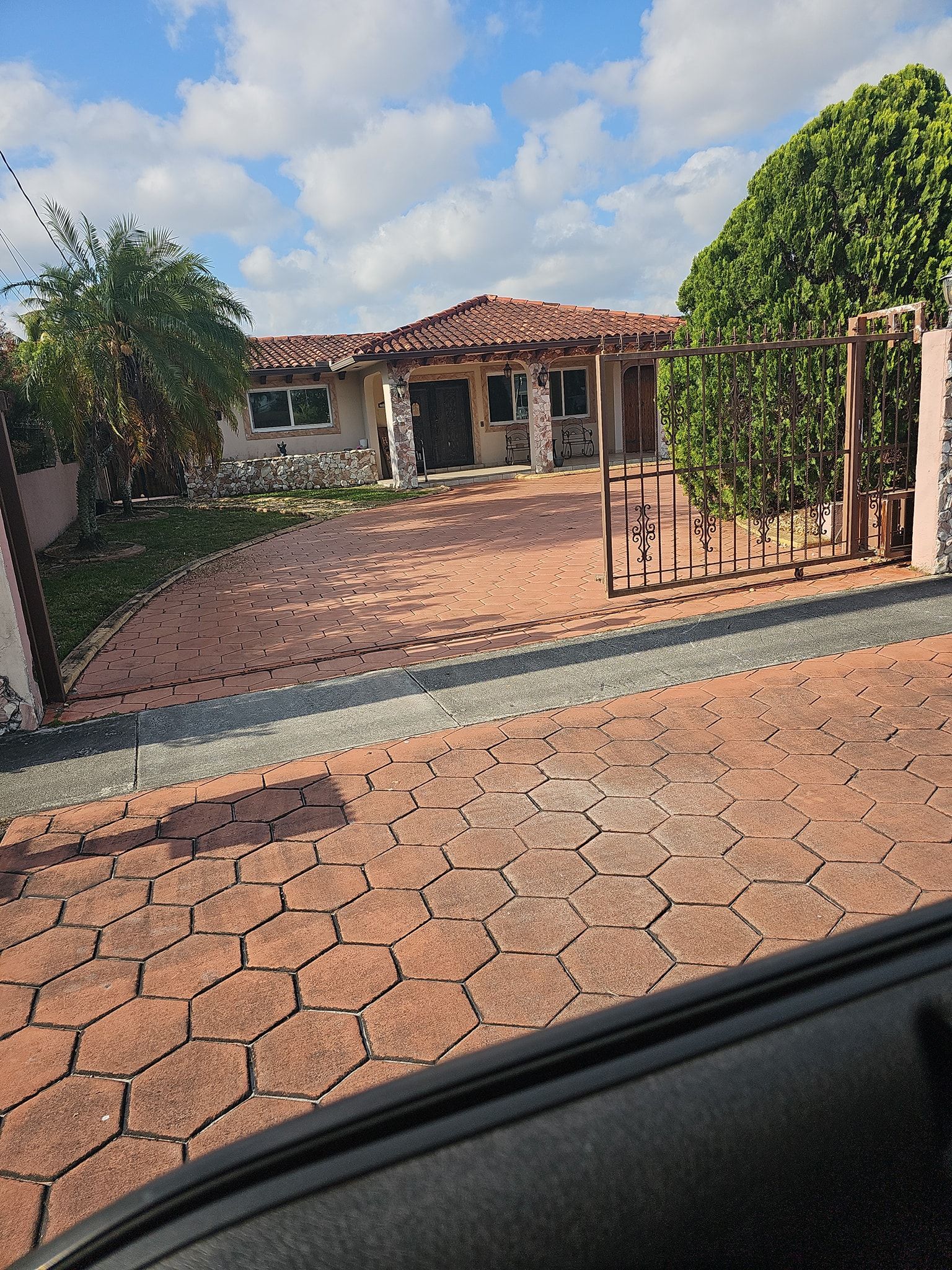 A view of a house from the inside of a car.