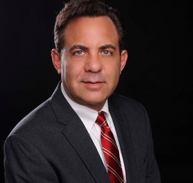 A man in a striped shirt is smiling for the camera.