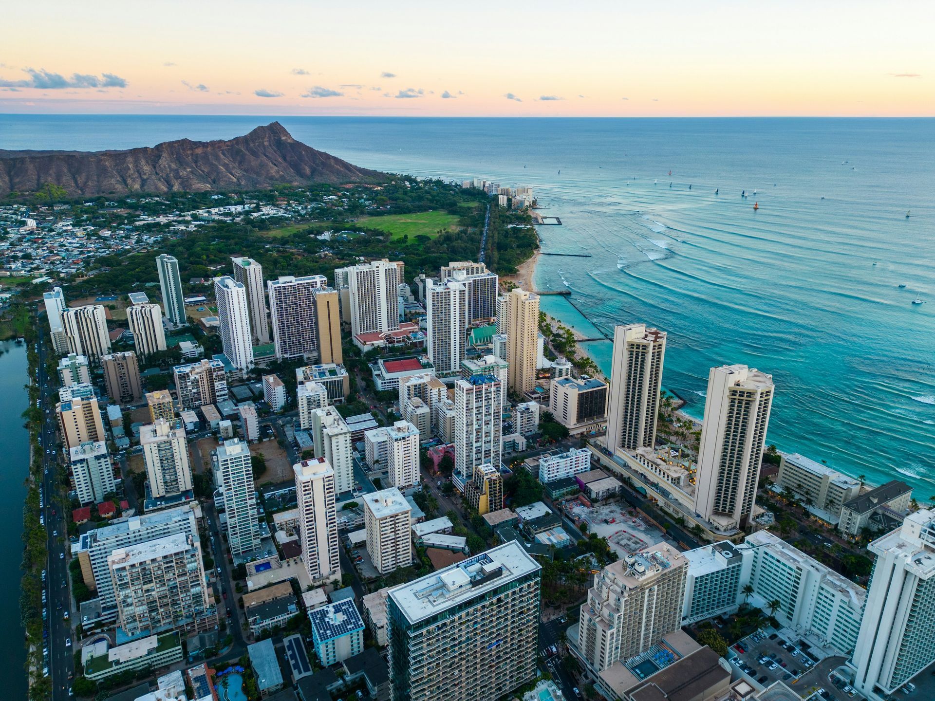Aerial view of Waikiki Beach and Diamond Head, Hawaii. High-rise buildings along the shoreline with turquoise water.