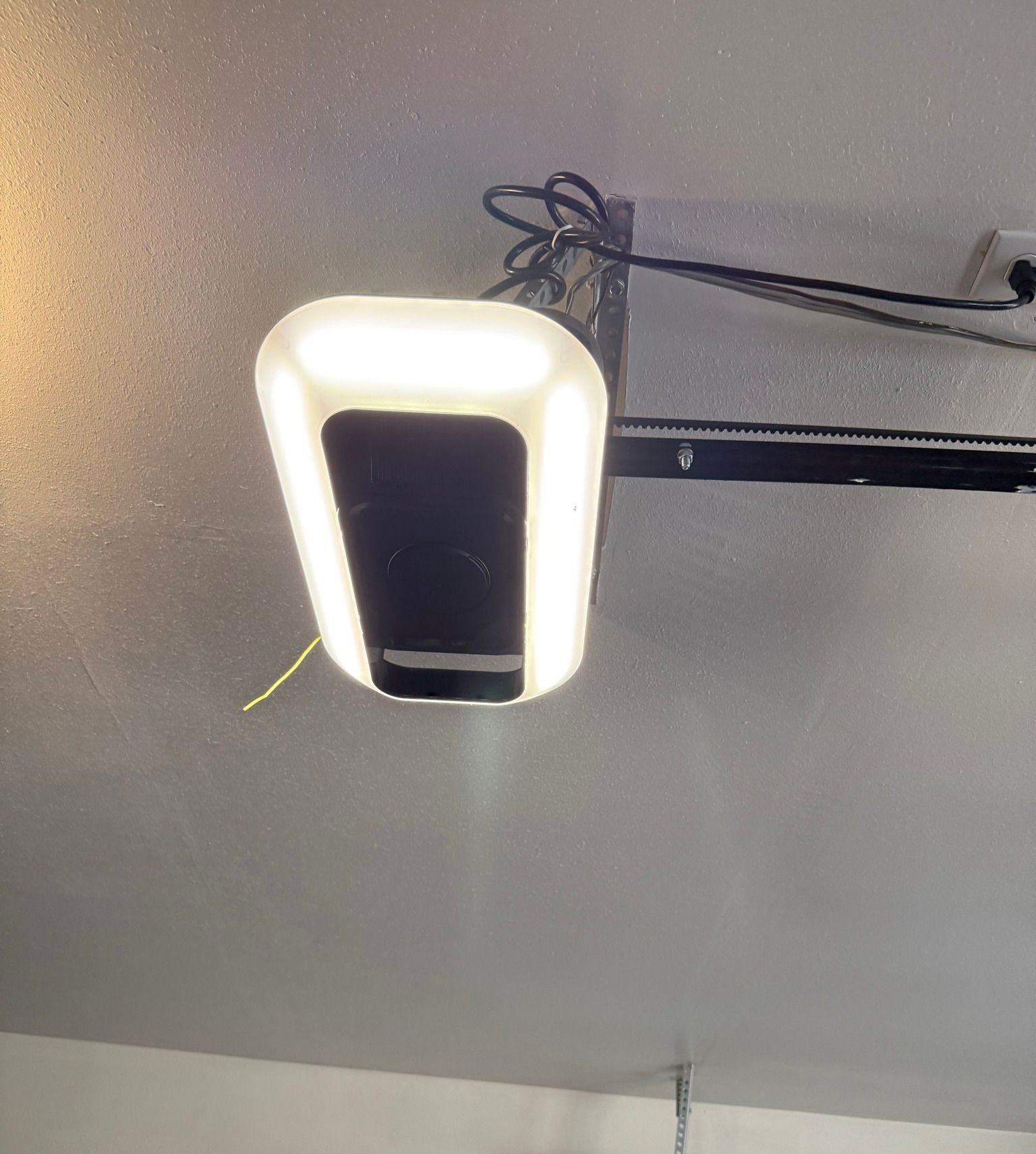 Black garage door with multiple glass panels, interior view of construction.