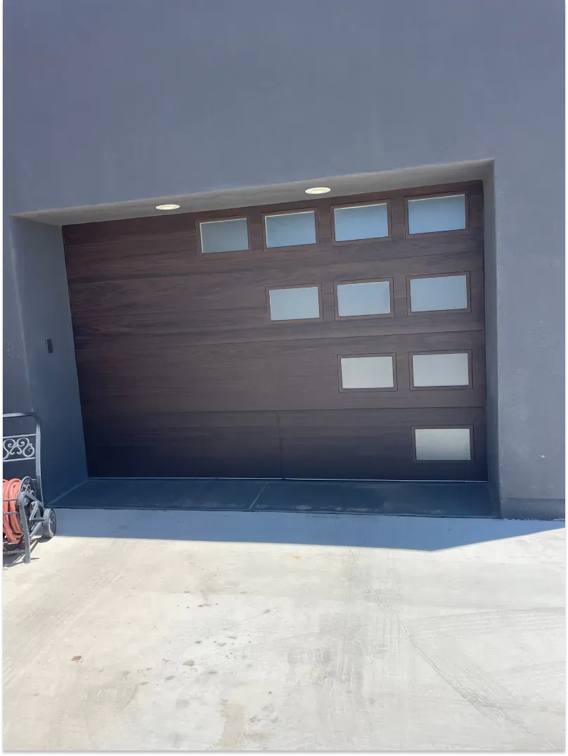 Brown garage door with frosted glass windows.