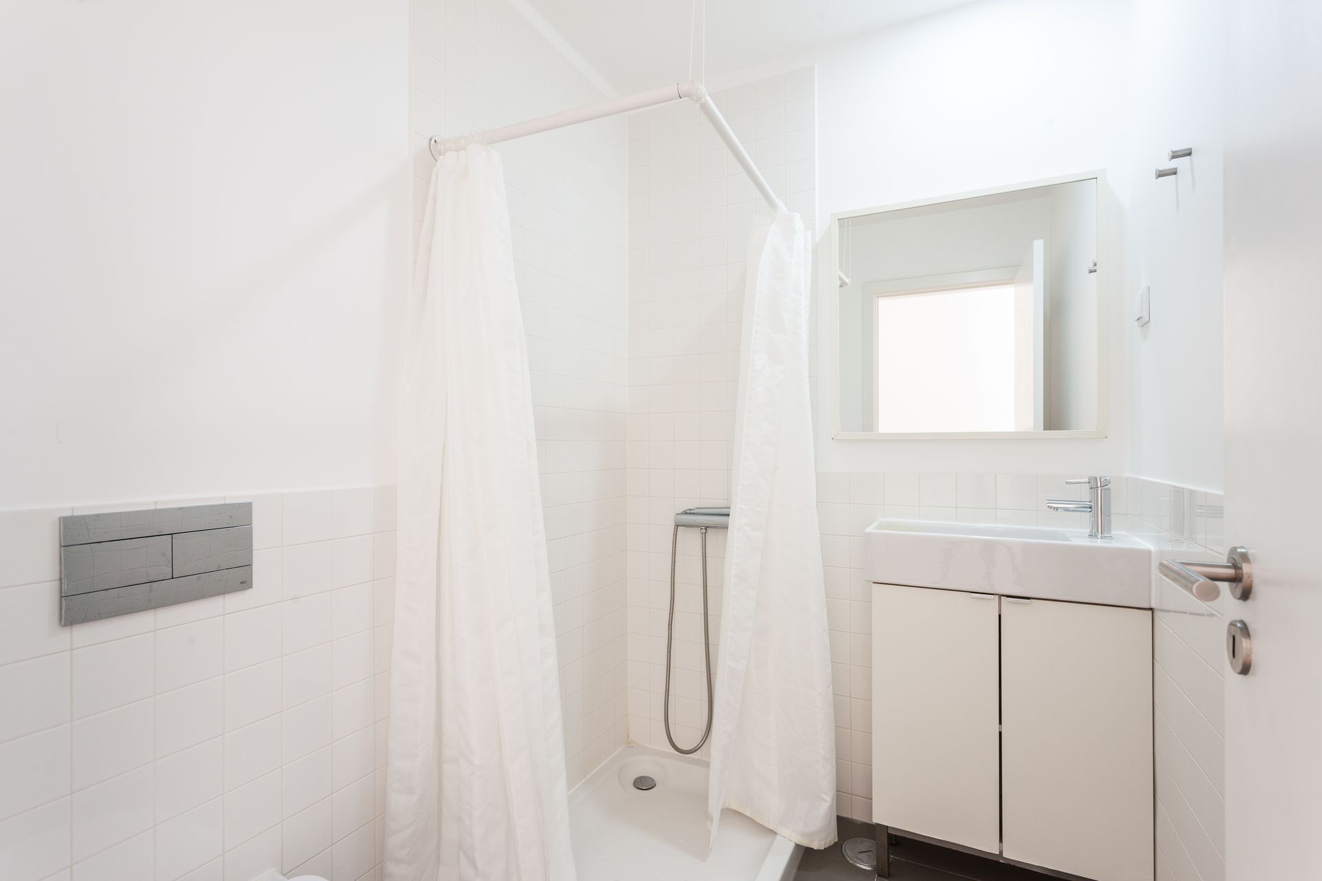 a bathroom with a shower curtain , sink and mirror .