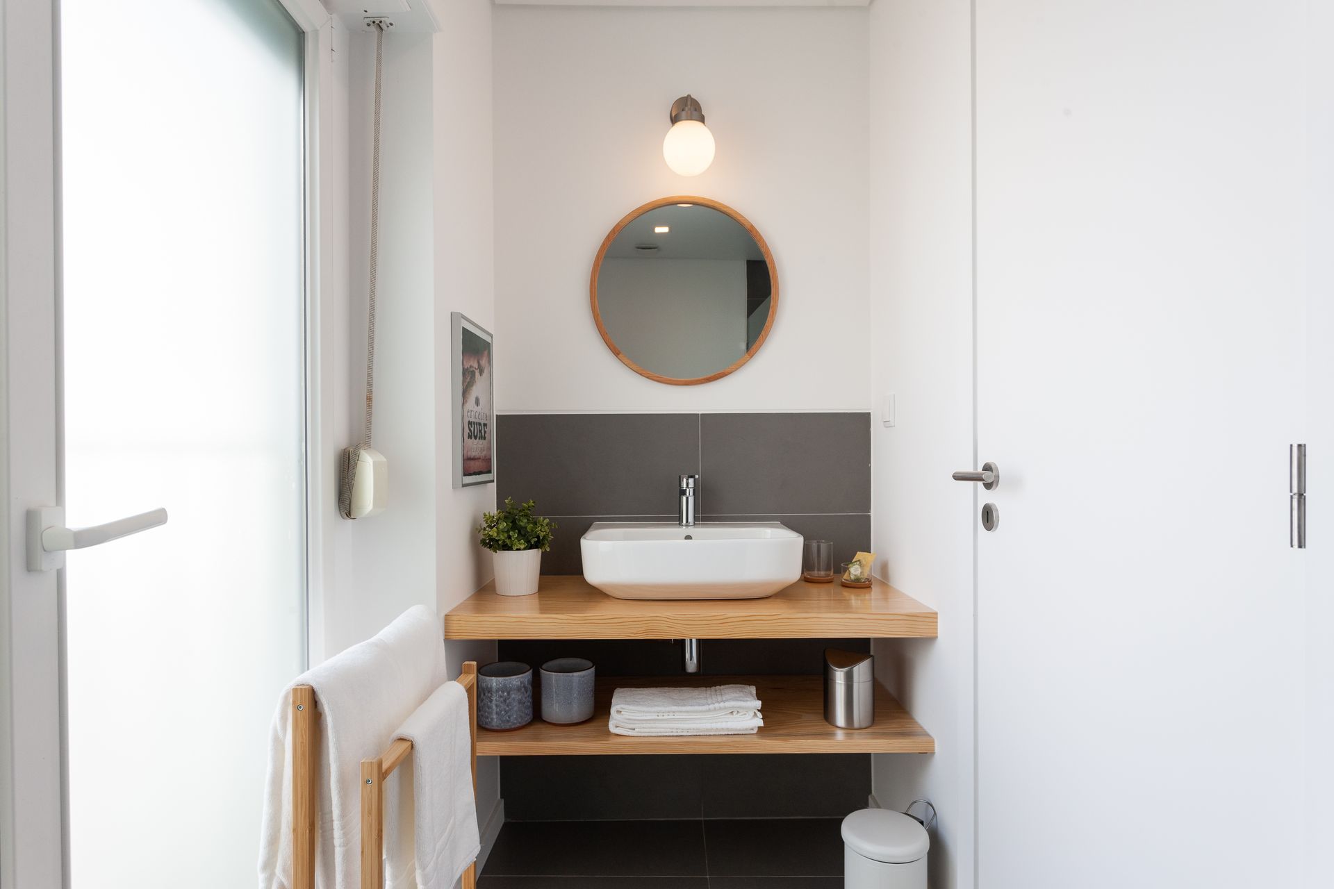 a bathroom with a sink , mirror and shelf .