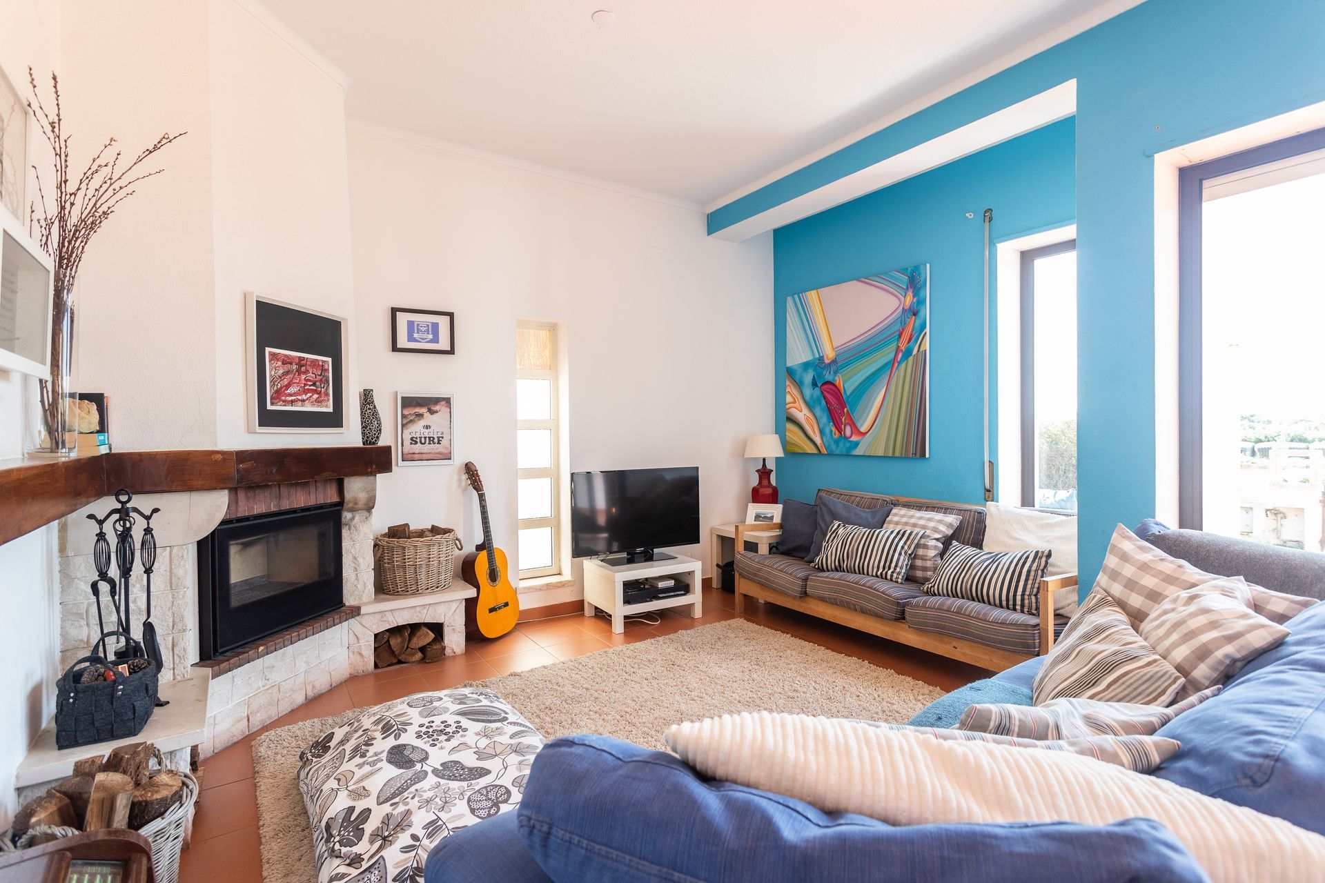 a living room with blue walls and a fireplace