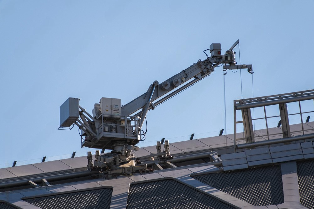 A large crane is sitting on top of a building.