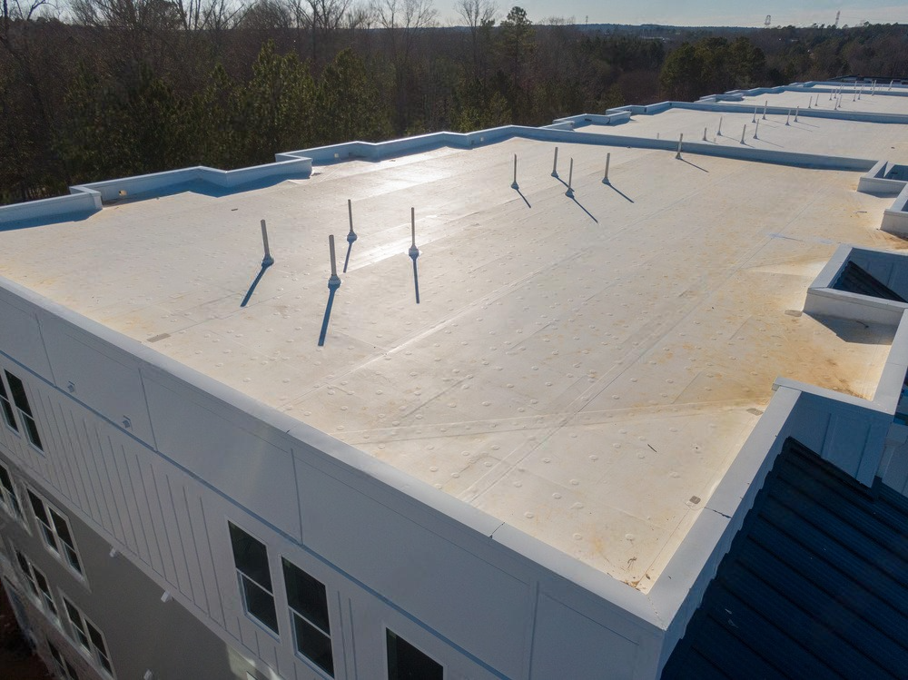 The roof of a building with a white roof and a blue roof.