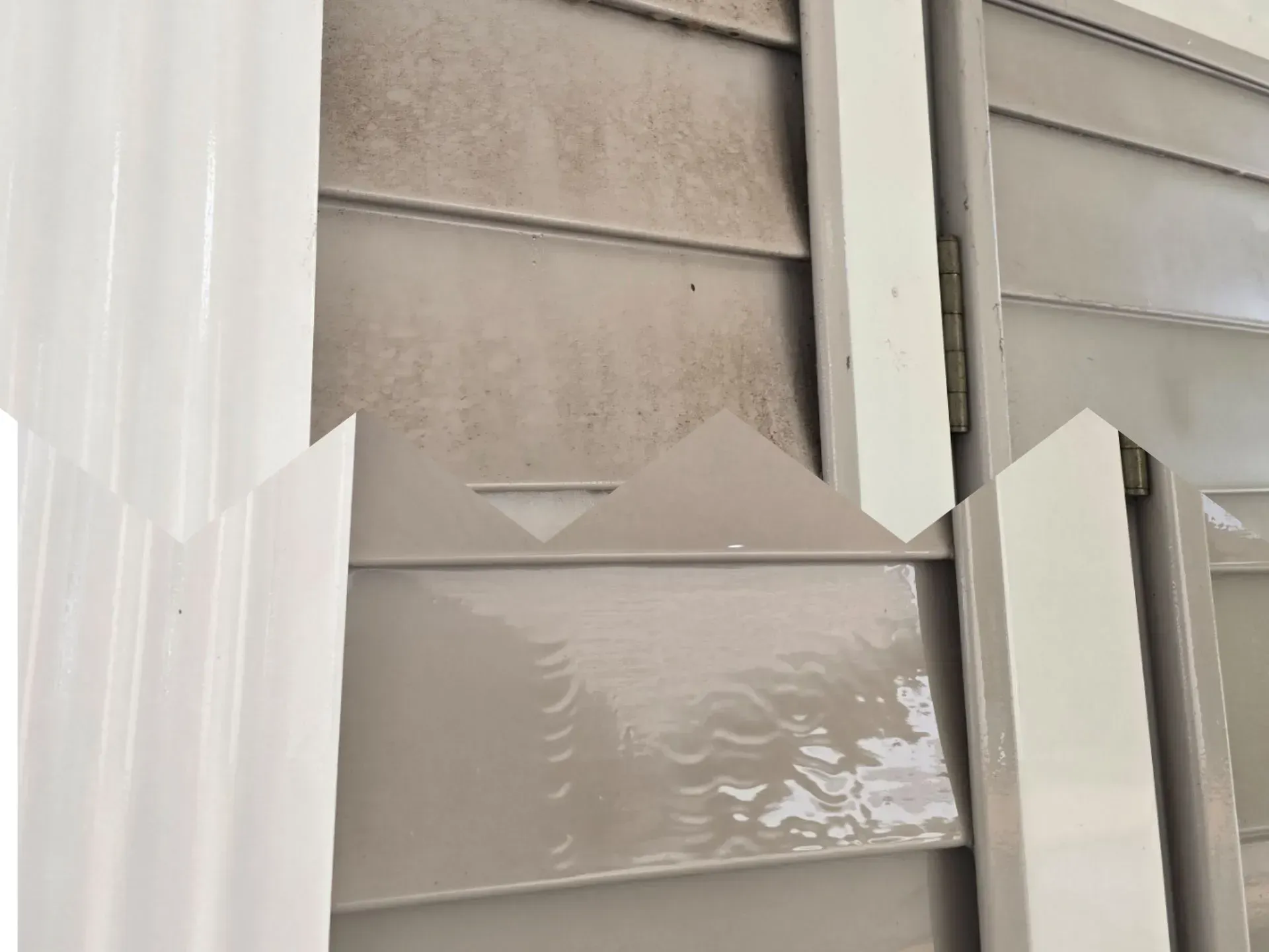 A close up of a door with a white trim on it.