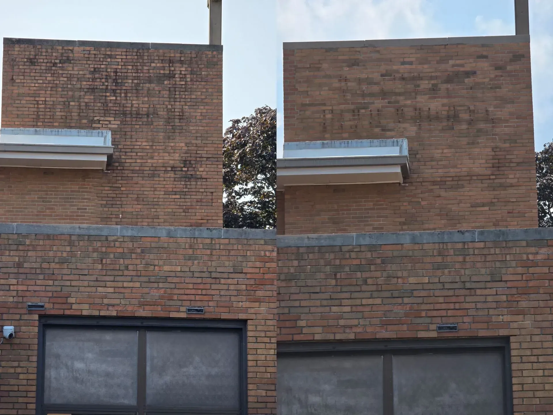 A brick building with two garage doors and a chimney