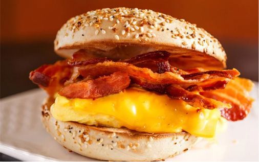 Everything bagel breakfast sandwich with egg, cheese, and bacon.