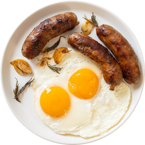 Plate of fried eggs and sausages with roasted garlic and rosemary.
