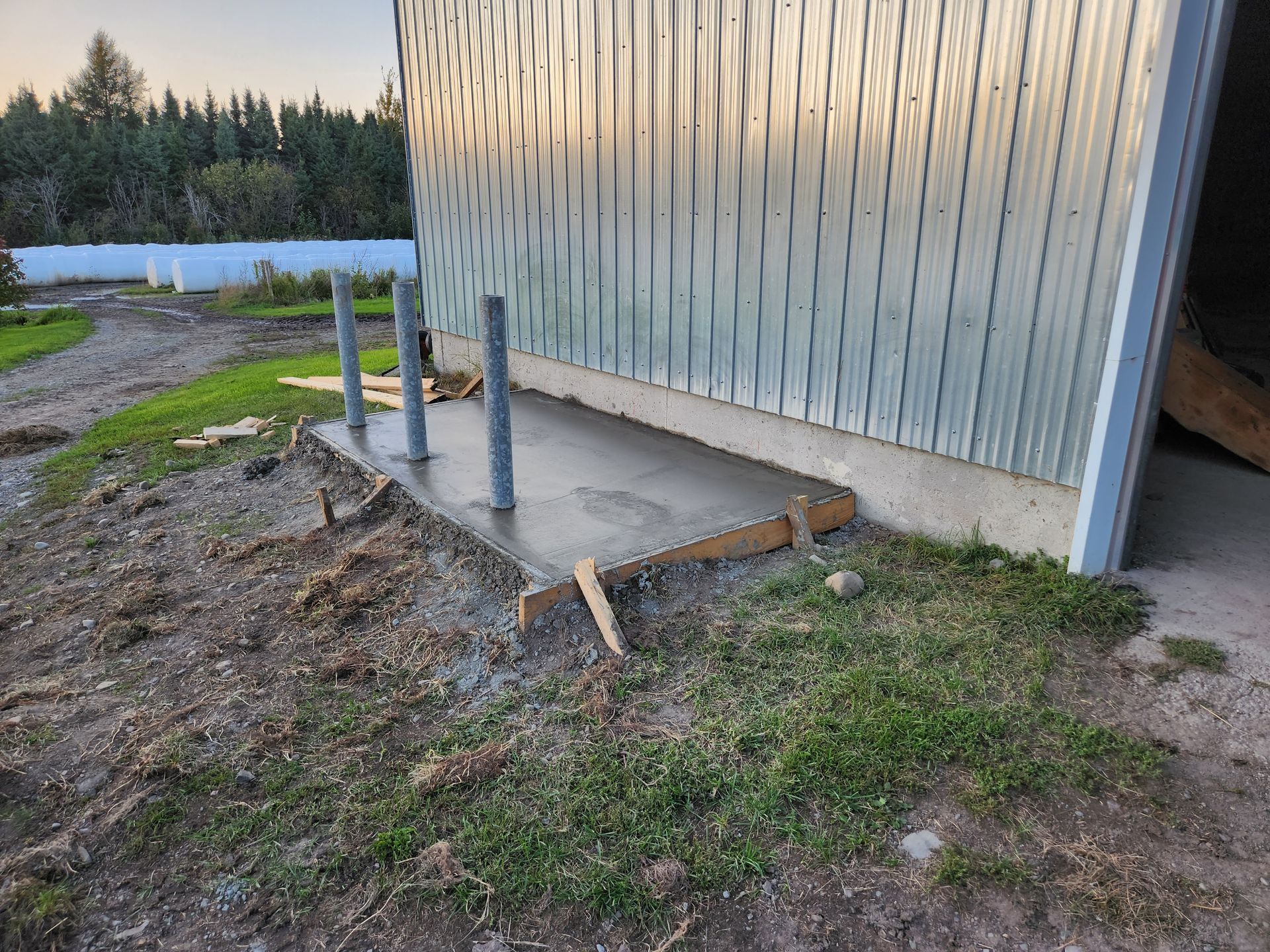 Une plateforme en béton est en cours de construction devant un bâtiment.