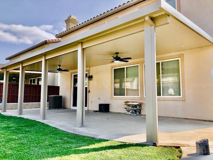 A house with a covered patio and a ceiling fan