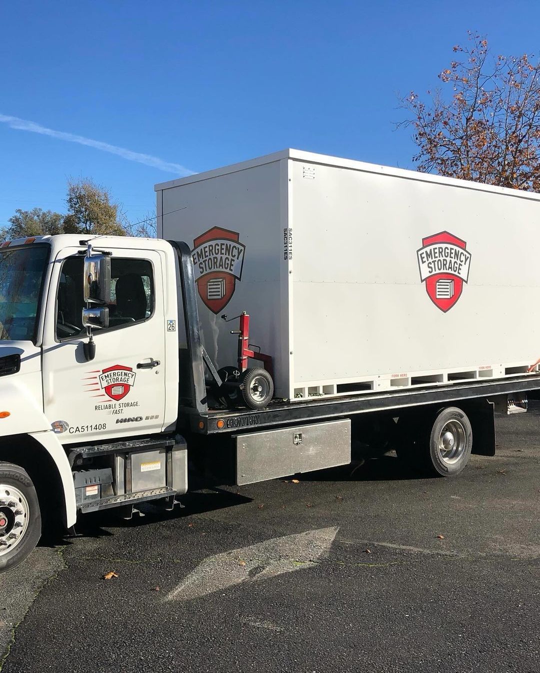 A white emergency storage truck is parked on the side of the road.