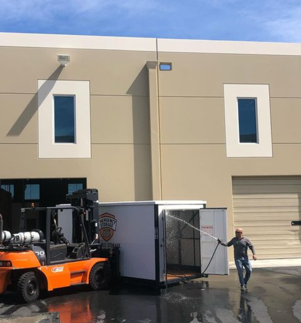 emergency storage unit at job site, man cleaning inside of unit