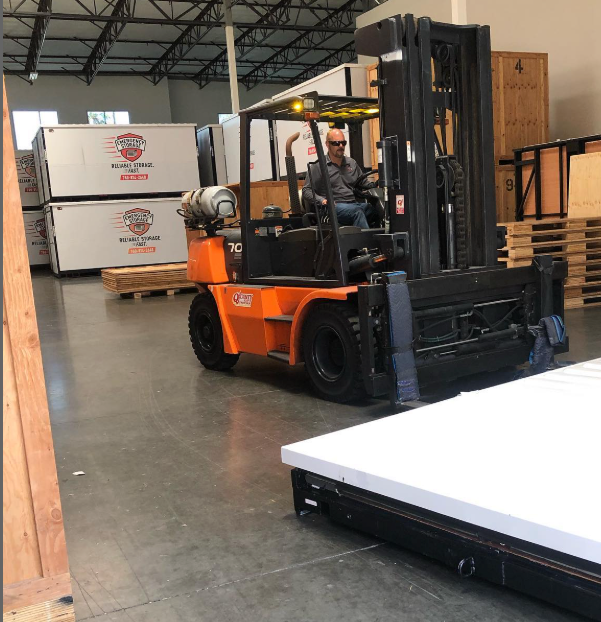 forlift operator moving storage units