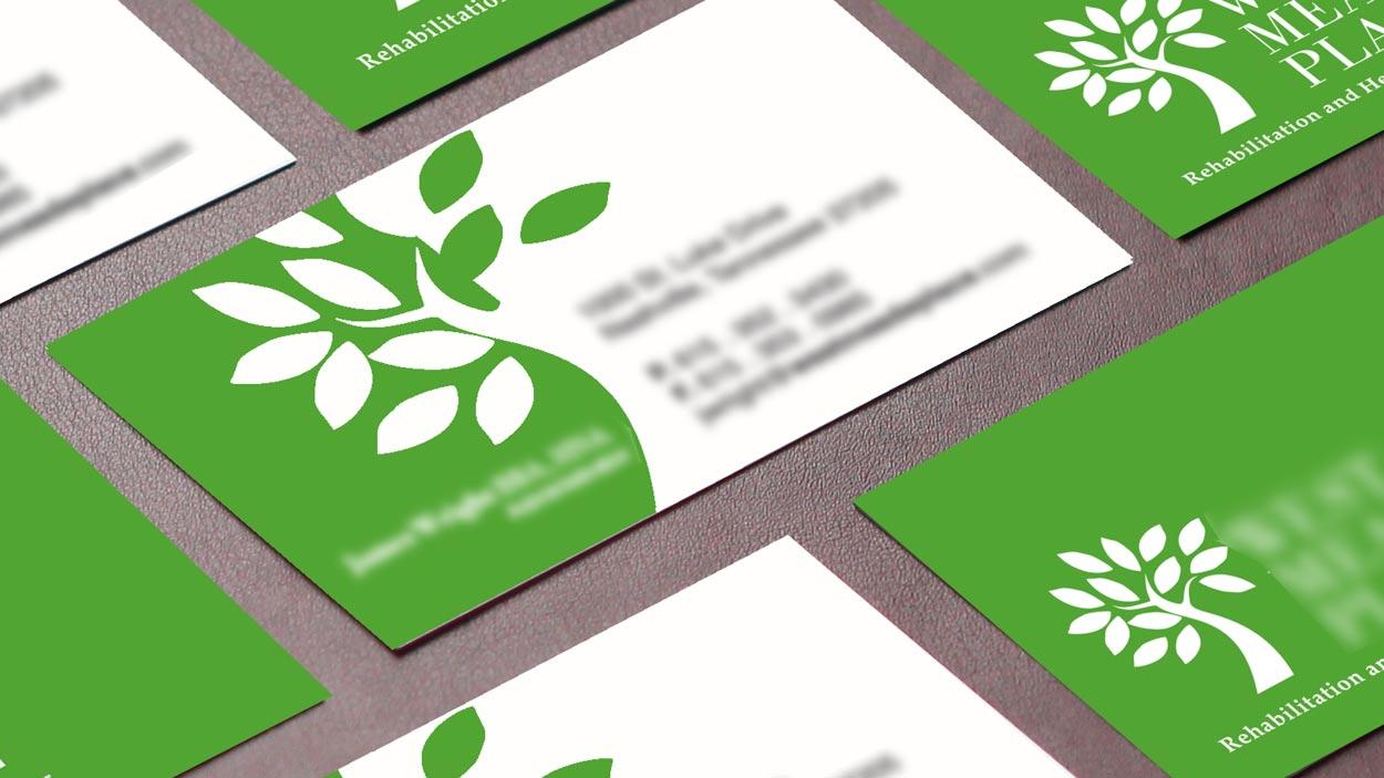 A green and white business card with a tree on it.