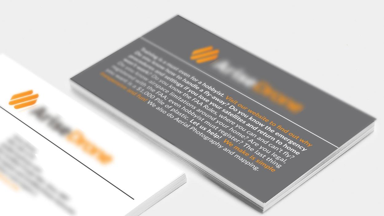 Two business cards are stacked on top of each other
