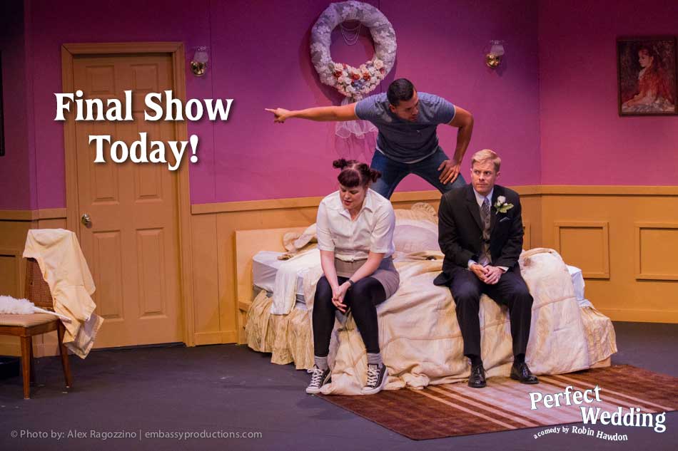 A group of people are sitting on a bed in a room.