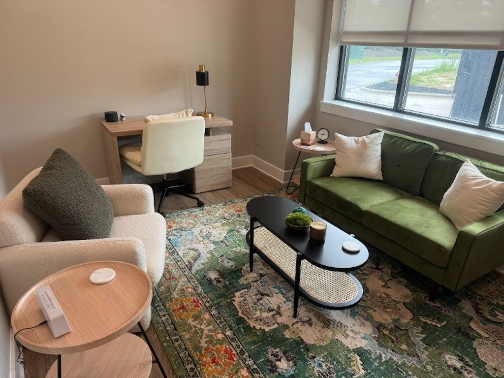 A man is sitting on a bench looking at the ocean.