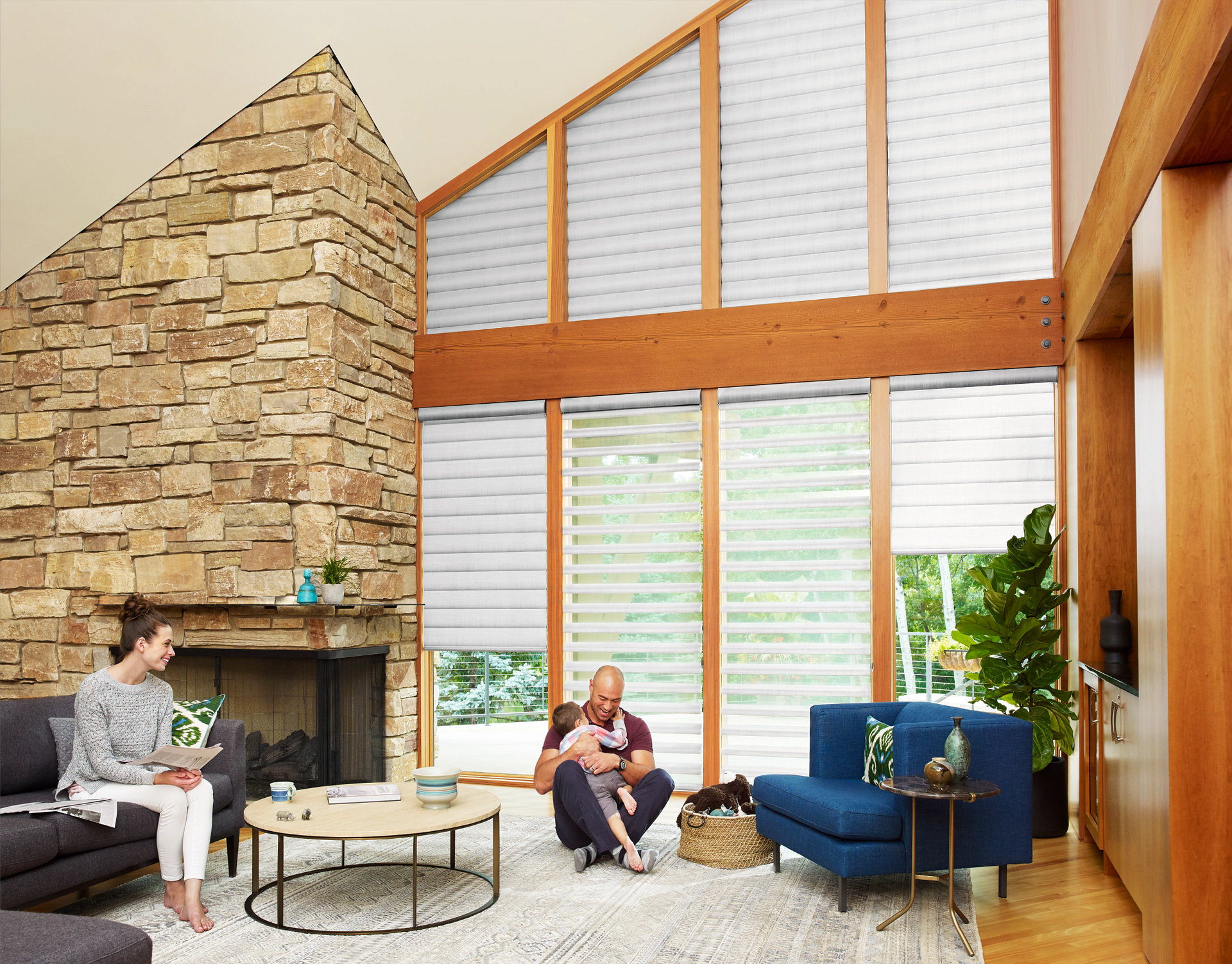 A family enjoying their living room with Hunter Douglas Pirouette® Sheer Shades.