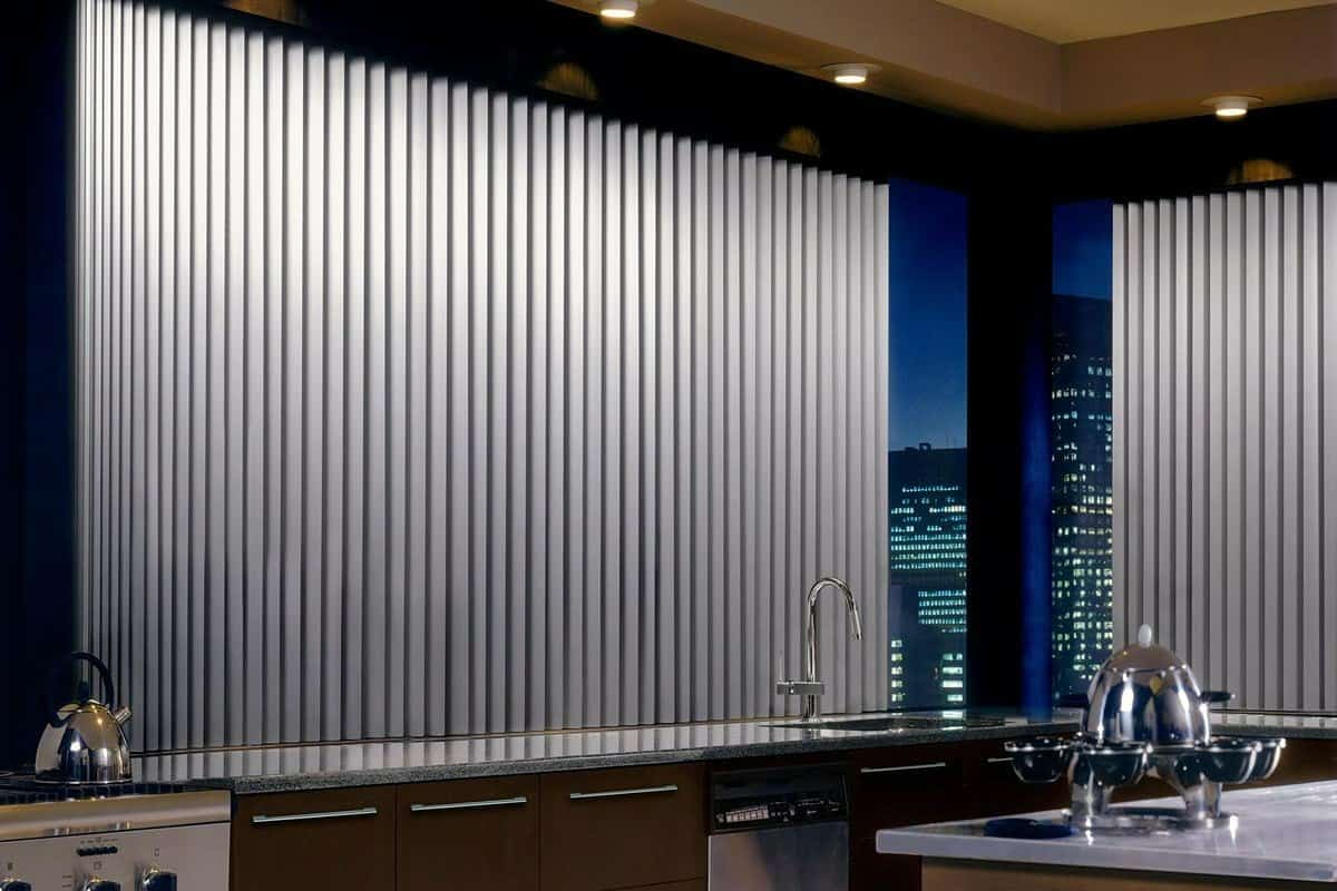 Hunter Douglas Somner® Custom Vertical Blinds almost fully closed in a kitchen window